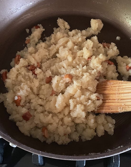 sooji halwa in a pan with broken cashews