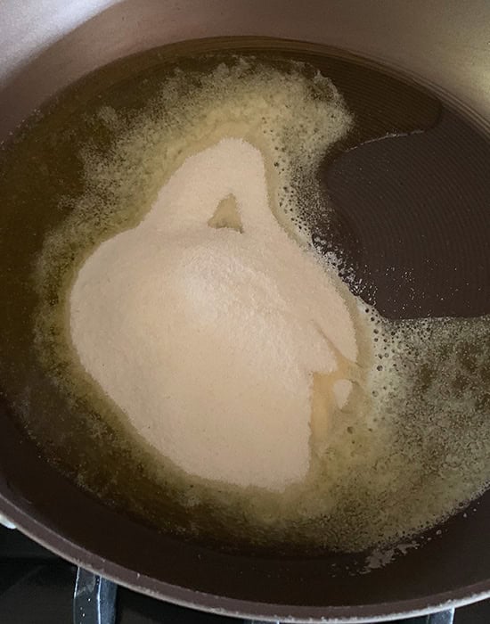 roasting sooji with ghee in a skillet