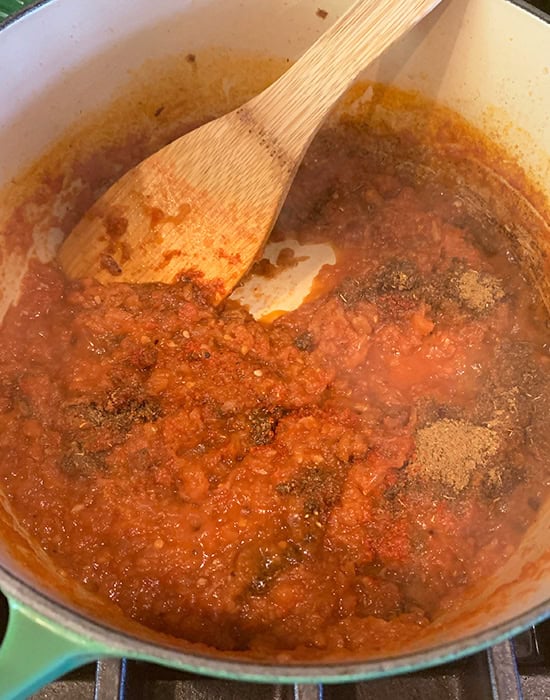 tomato puree with spices in a pot