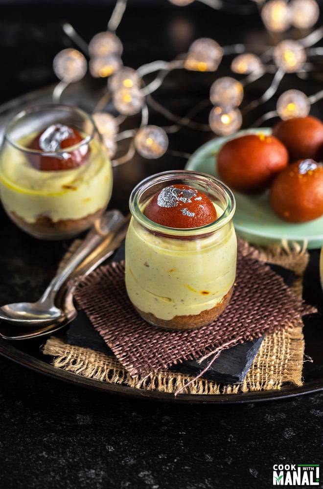 small jars filled with shrikhand and topped with gulab jamun