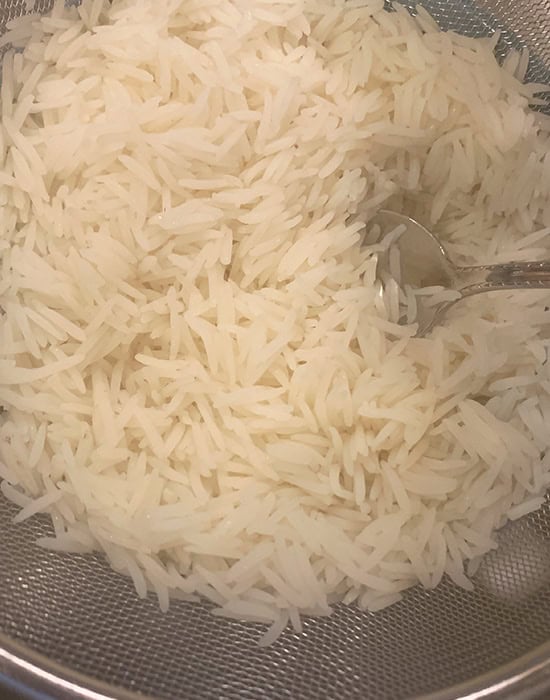 fluffing rice with a fork