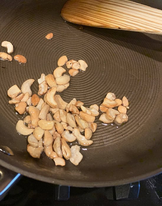 frying cashews in a pan