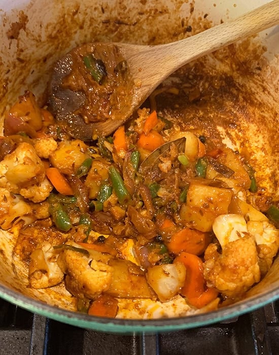 cooked vegetables for biryani in a pot