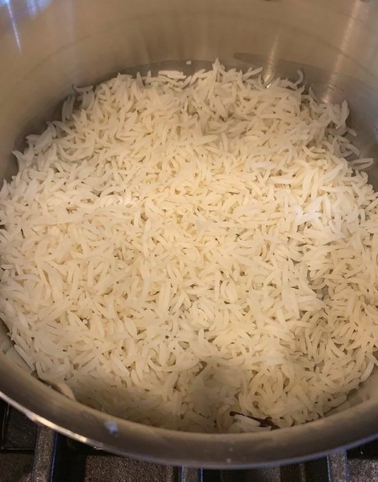 rice layered in a steel stockpot
