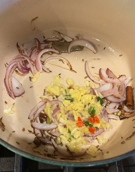 sliced onions with ginger and garlic in a pot
