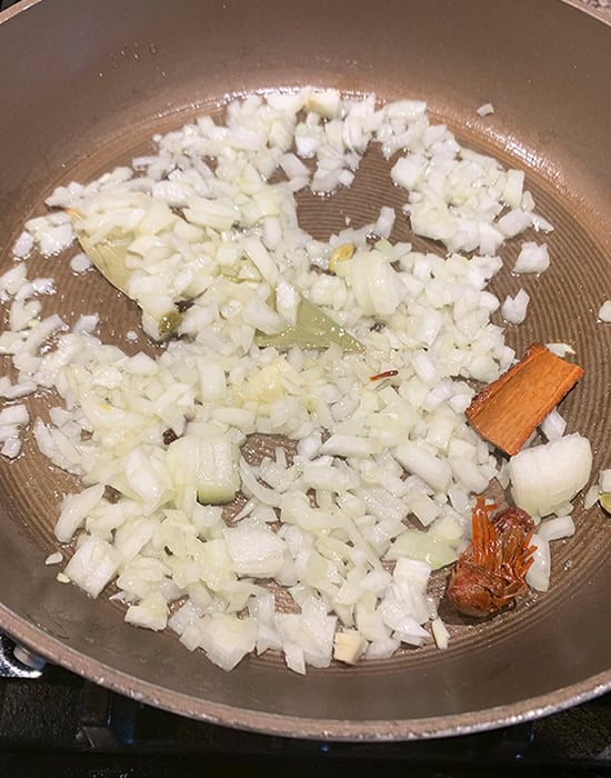 onions with spices in a pan