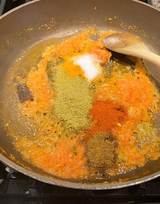 powdered spices added to onion tomato masala