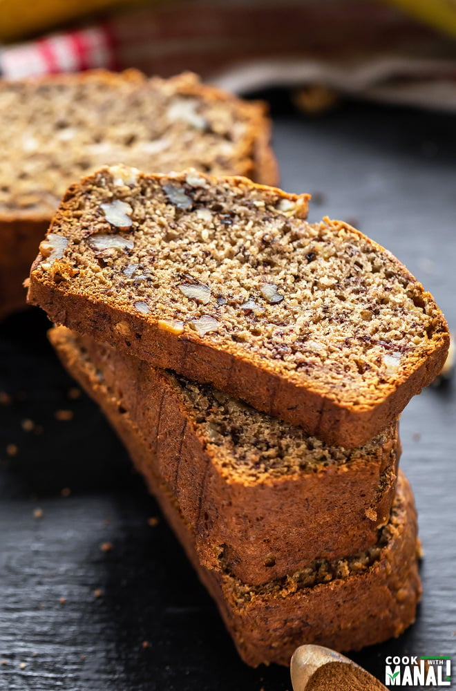 stack of banana bread with the top most slice placed in a way to show the texture of the bread