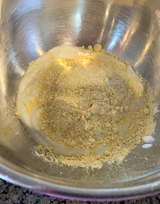 yogurt with besan in a steel bowl