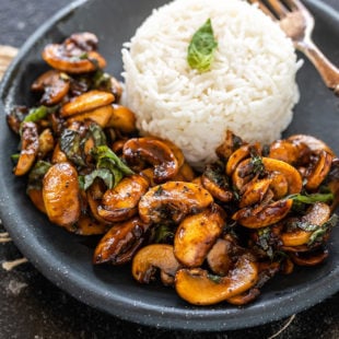 balsamic mushrooms placed in a round plate along with white rice