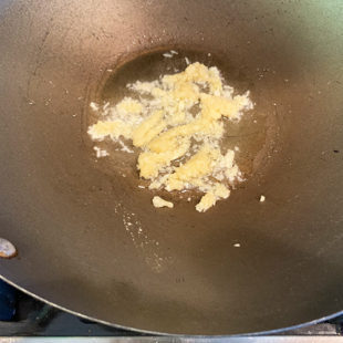 grated garlic in a wok