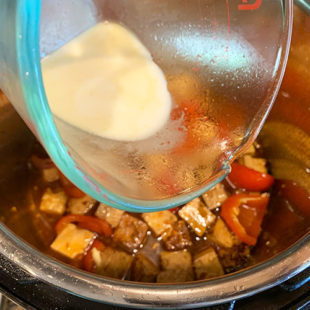 cornstarch slurring being added to a pot