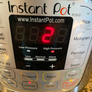 instant pot displaying 2 minute sign