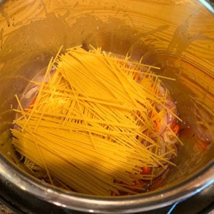 spaghetti noodles arranged in a criss-cross manner in instant pot