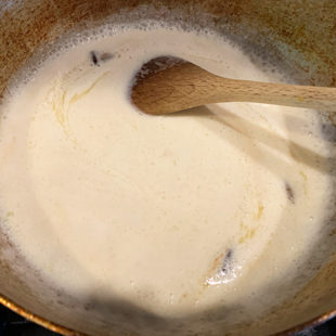 wok with a white smooth paste with a spatula