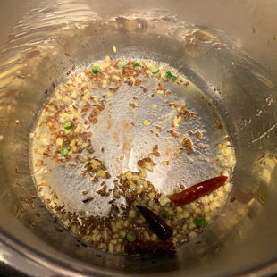 cumin, red chilies, ginger being sauteed in instant pot
