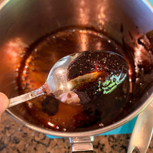 thick balsamic glaze coating the back of a spoon