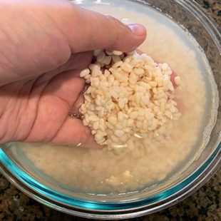 urad dal being soaked in bowl of water