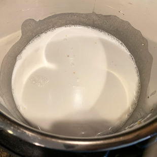 white color liquid in a steel pot