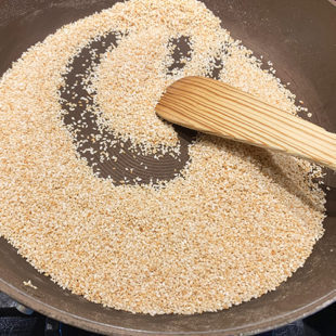 white sesame seeds being roasted in a pan