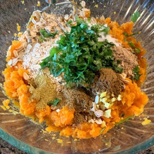 glass bowl with mashed potatoes, spices, cilantro