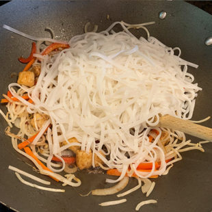 noodles with stir-fry veggies in a wok