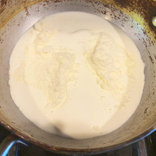 cream and milk powder in a pan