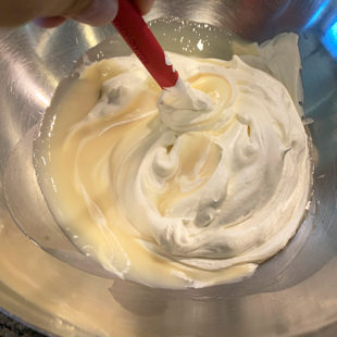 whipped cream being mixed into condensed milk