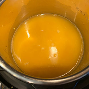 dal with turmeric and water in the steel pot