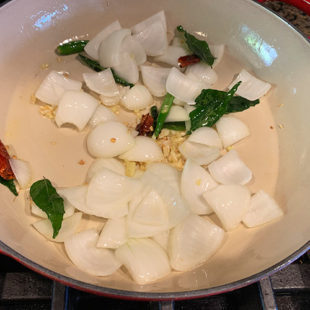 onions, curry leaves, ginger, garlic added to a pan