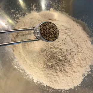 carom seeds being adding to wheat flour