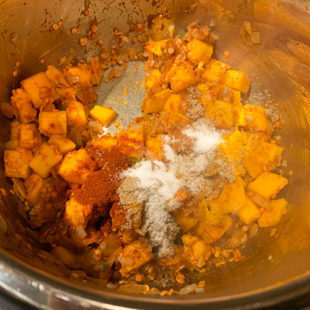 diced butternut squash, lentils and spices in a pot