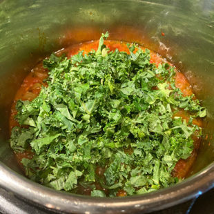 chopped kale added to a soup