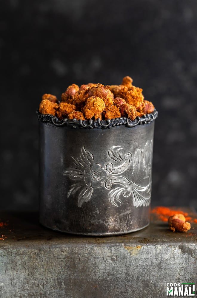 masala peanuts placed in a silver antique glass