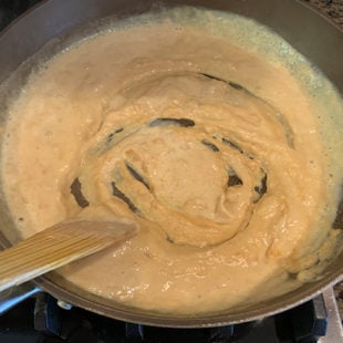 whitish yellow color paste being stirred in a pan