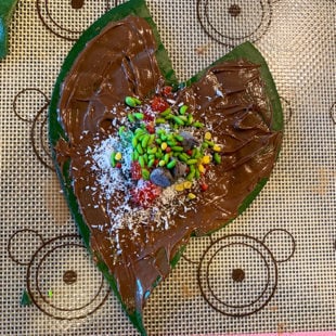 paan leaf topped with tutti frutti, coconut powder