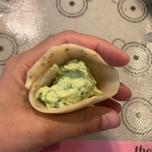 samosa being filled with a cream cheese filling