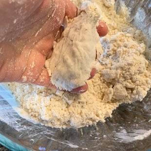 hand pressing some dough to show it's holding it's shape