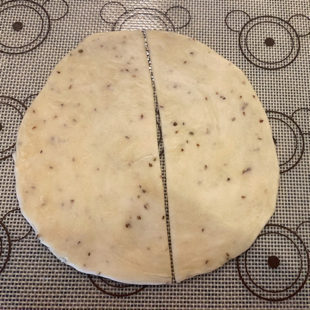 rolled circular dough cut into 2 parts