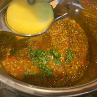 lemon juice being squeezed in dal