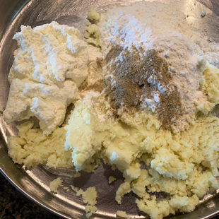 plate with mashed mawa, flour, cardamom powder