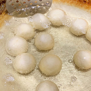 round dough balls in hot oil