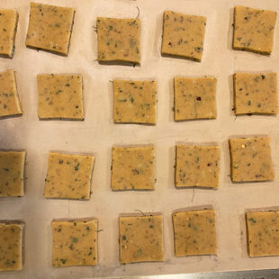 square shaped cookies arranged on a baking sheet