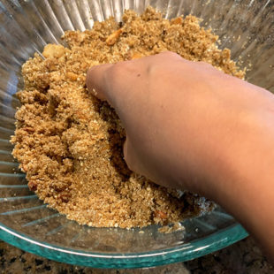hand mixing flour in a bowl