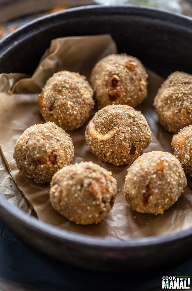 8 round balls made of quinoa placed in a black round pan