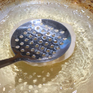 dough being fried in oil