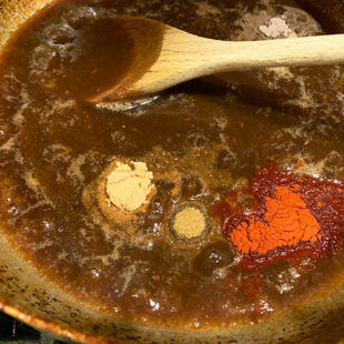 brown color liquid in a kadai with spices