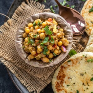 matar chaat in a bowl made of leaves and kulcha placed on the side