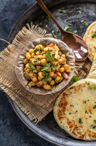 matar chaat in a bowl made of leaves and kulcha placed on the side