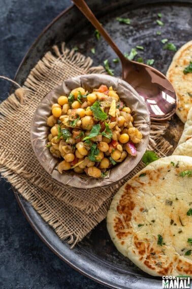 matar chaat in a bowl made of leaves and kulcha placed on the side